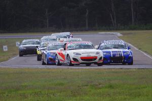 Playboy Mazda MX-5 Cup cars come into turn 4 on the first lap