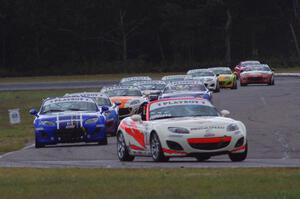 Playboy Mazda MX-5 Cup cars come into turn 4 on lap 2