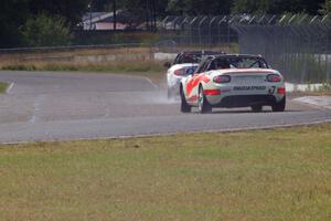 Dean Copeland's Mazda MX-5 drifts through turn 6 on the cool-off lap