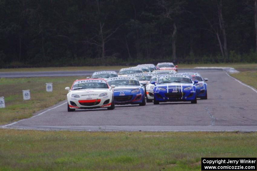 Playboy Mazda MX-5 Cup cars come into turn 4 on the first lap