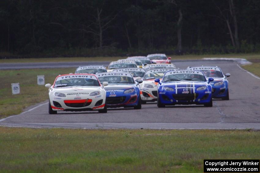 Playboy Mazda MX-5 Cup cars come into turn 4 on the first lap