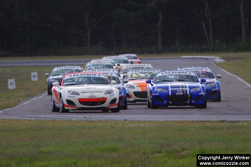 Playboy Mazda MX-5 Cup cars come into turn 4 on the first lap