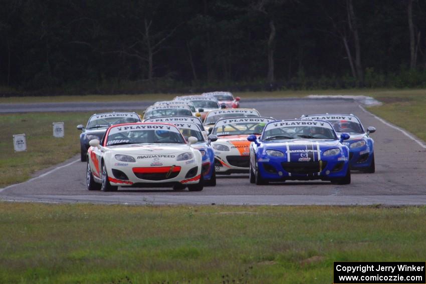 Playboy Mazda MX-5 Cup cars come into turn 4 on the first lap