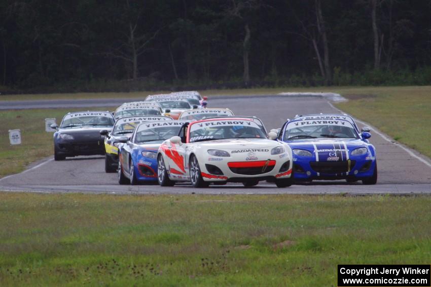 Playboy Mazda MX-5 Cup cars come into turn 4 on the first lap