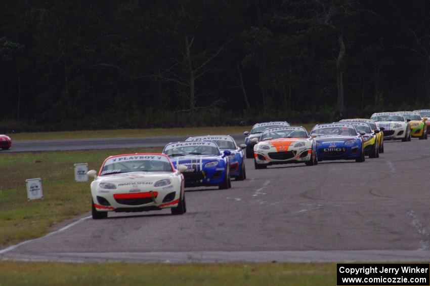 Playboy Mazda MX-5 Cup cars come into turn 4 on lap 2