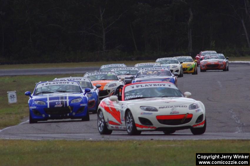 Playboy Mazda MX-5 Cup cars come into turn 4 on lap 2