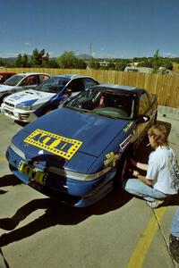 Last minute prep work is done on the Eagle Talon of Steve Gingras / Eric Carlson at parc expose by Johnny Parker.