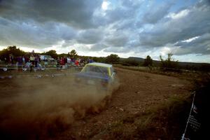 The Carl Jardevall / John Elkin Volvo 740 blasts gravel through the spectator corner at sunset.