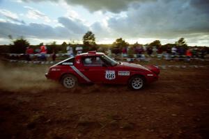 The Doug Robinson / Chrissie Beavis Mazda RX-7 comes through the spectator point just before sundown.