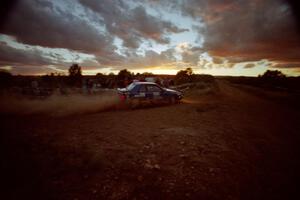 The Kendall Russell / Lynn Dillon Dodge Shadow comes through the specator corner into a long straight with a beautiful sunset.