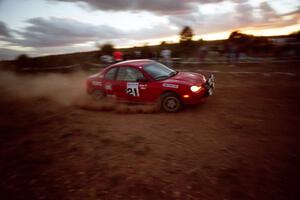 The Trevor Donison / John Allen Dodge Neon ACR at speed through the spectator point at sundown.