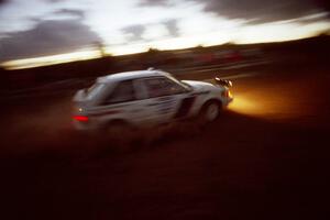 The Paul Timmerman / S. Martin Mazda 323GTX comes through the spectator corner at sundown.