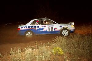 The Noel Lawler / Charles Bradley Hyundai Elantra at speed through the spectator coner at night.