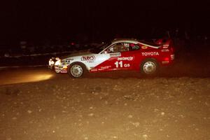 The Ralph Kosmides / Joe Noyes Toyota Supra Turbo comes through the spectator point at night.