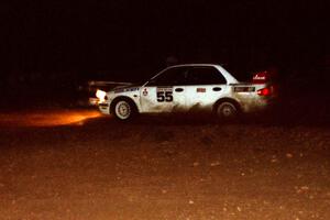 Tony Takaori / Ken Cassidy Mitsubishi Lancer Evo III at speed at night through the spectator corner.