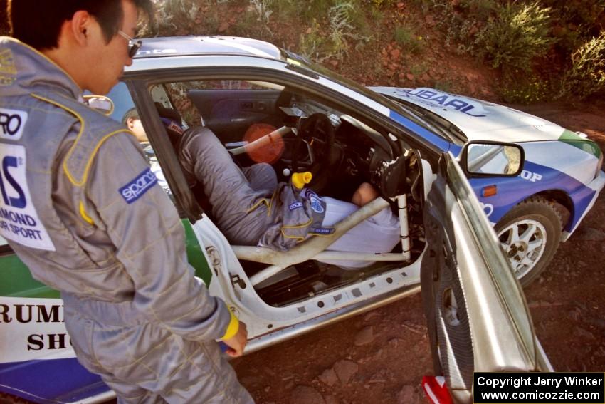 Last minute under-dash electrical work for the Hiroyuki Genta / Kazmasa Takata Subaru Impreza before the first stage.