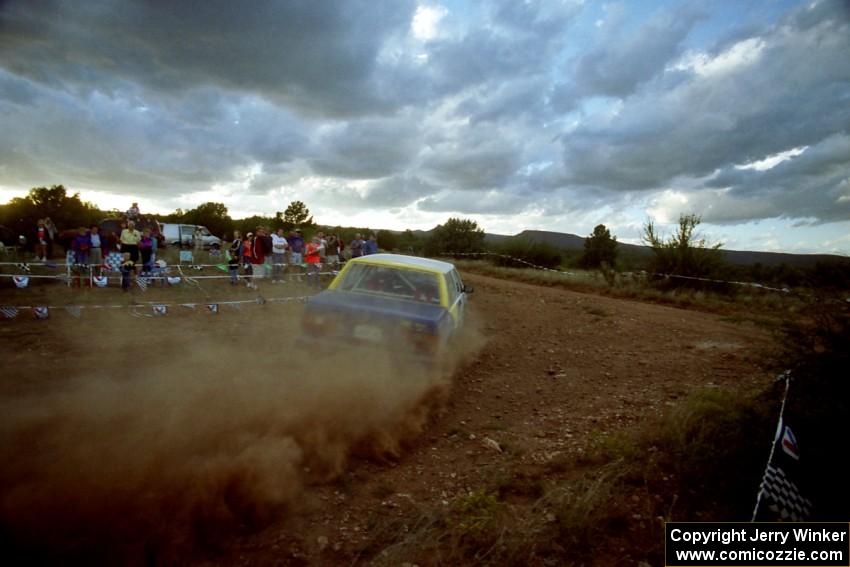 The Carl Jardevall / John Elkin Volvo 740 blasts gravel through the spectator corner at sunset.