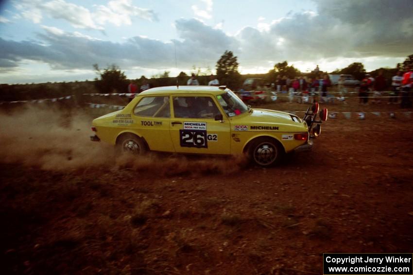 The Tom Bier / Ole Holter SAAB 99 through the spectator corner at sundown.