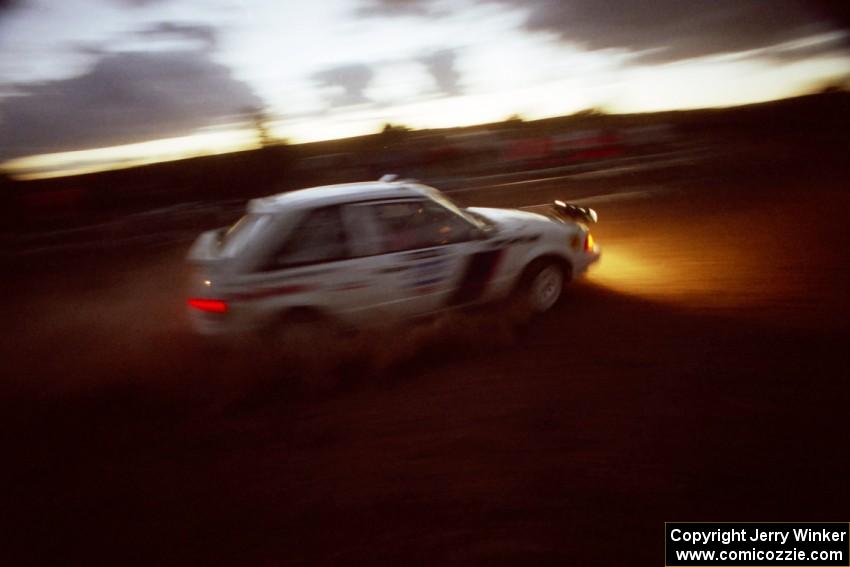 The Paul Timmerman / S. Martin Mazda 323GTX comes through the spectator corner at sundown.