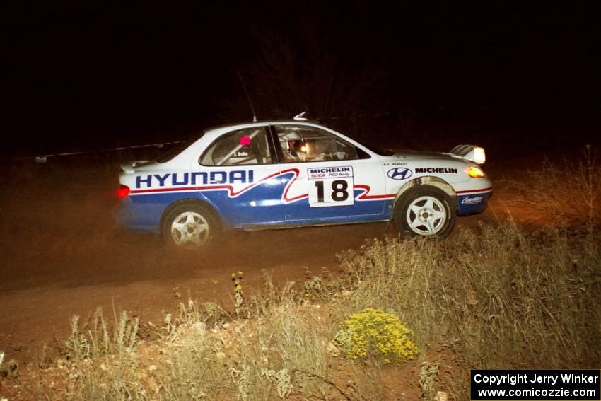 The Noel Lawler / Charles Bradley Hyundai Elantra at speed through the spectator coner at night.