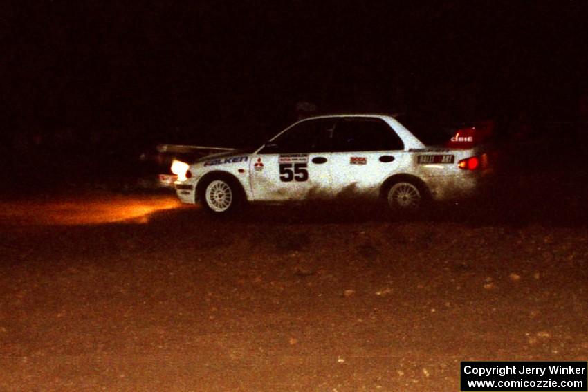 Tony Takaori / Ken Cassidy Mitsubishi Lancer Evo III at speed at night through the spectator corner.