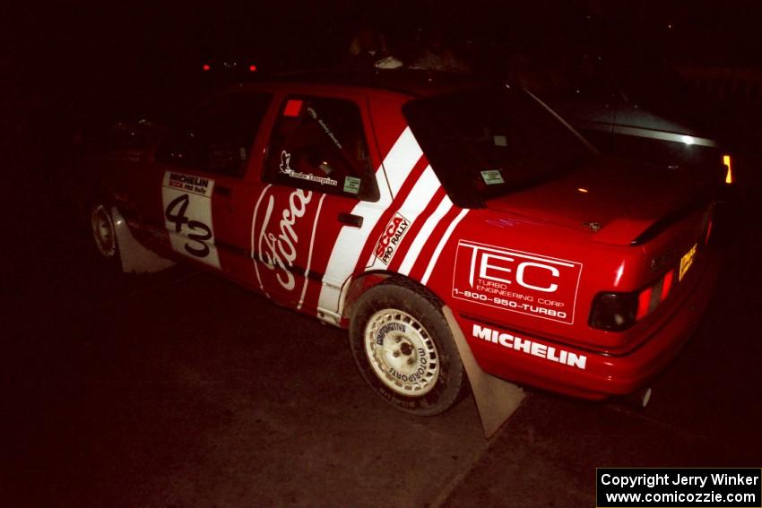 The Mike Whitman / Paula Gibeault Ford Sierra Cosworth checks into the final MTC at the headquarters.