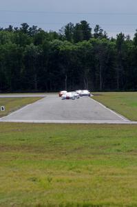 Tony Ave leads Tomy Drissi, R.J. Lopez, Bobby Sak, Jim Derhaag, Simon Gregg and Buddy Cisar on the first lap into turn 4.