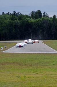 Tony Ave leads Tomy Drissi, R.J. Lopez, Bobby Sak, Jim Derhaag, Simon Gregg and Buddy Cisar on the first lap into turn 4.