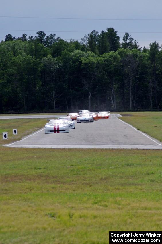 Tony Ave leads Tomy Drissi, R.J. Lopez, Bobby Sak, Jim Derhaag, Simon Gregg and Buddy Cisar on the first lap into turn 4.