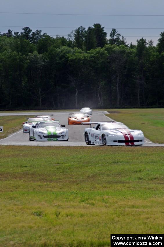 Tony Ave leads Tomy Drissi, R.J. Lopez, Bobby Sak, Jim Derhaag, Simon Gregg and Buddy Cisar on the first lap into turn 4.