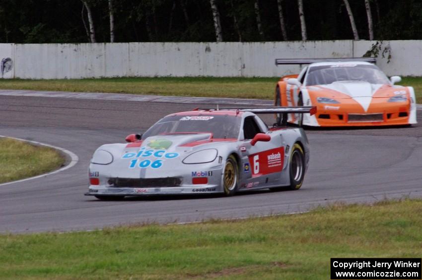 R.J. Lopez tries to fend off Simon Gregg, both in Chevy Corvettes