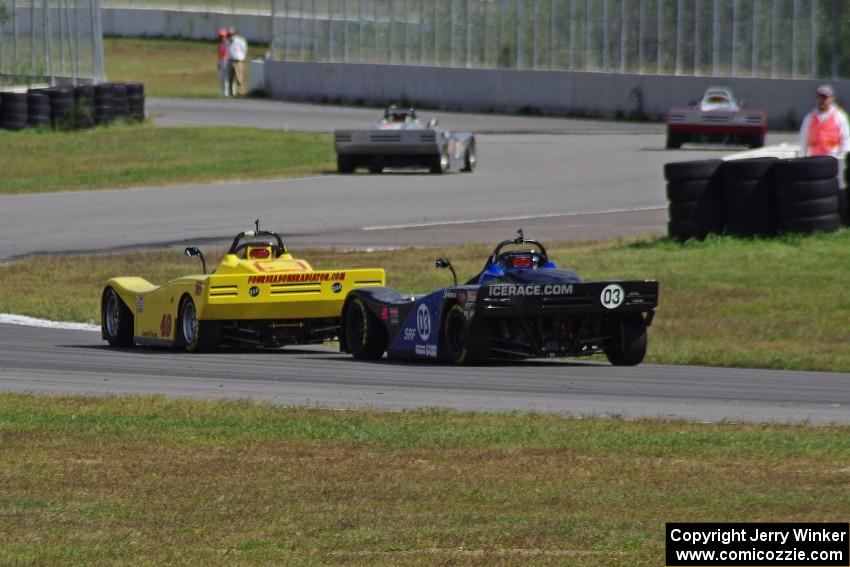 Carl Harris' and Robert Reed's Spec Racer Fords exit the carousel