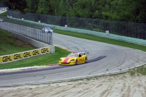 Tony Ave's Chevy Corvette leads Cliff Ebben's Ford Mustang and Daniel Ramoutarsingh's Jaguar XKR on lap one headed into turn 12