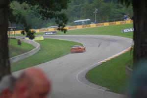 Doug Harrington's Chevy Corvette limps uphill into turn 13 after wrecking