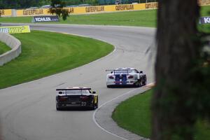 Daniel Ramoutarsingh's Jaguar XKR and Carlos de Quesada's Jaguar XKR head uphill into turn 13