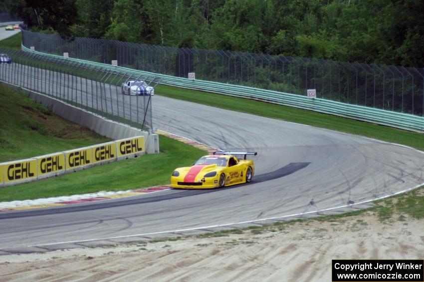 Tony Ave's Chevy Corvette leads Cliff Ebben's Ford Mustang and Daniel Ramoutarsingh's Jaguar XKR on lap one headed into turn 12