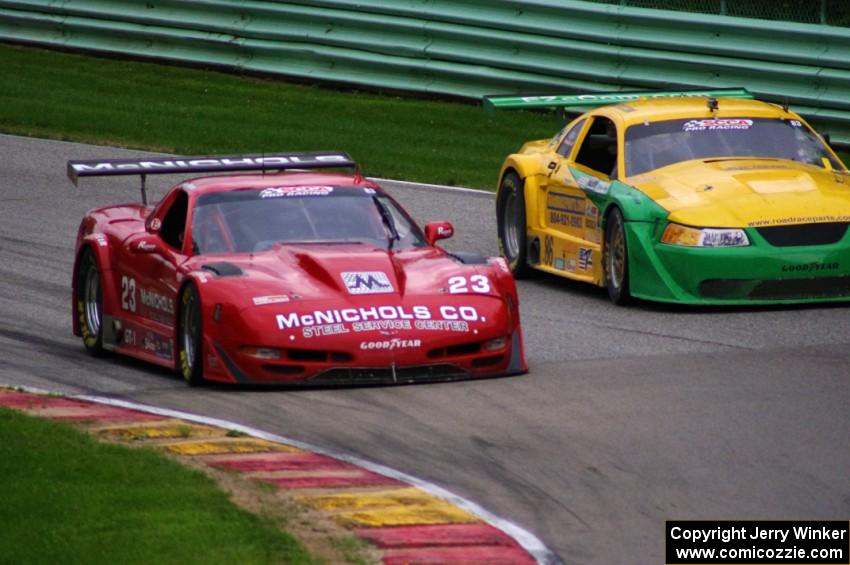 Amy Ruman's Chevy Corvette inside of John Baucom's Ford Mustang