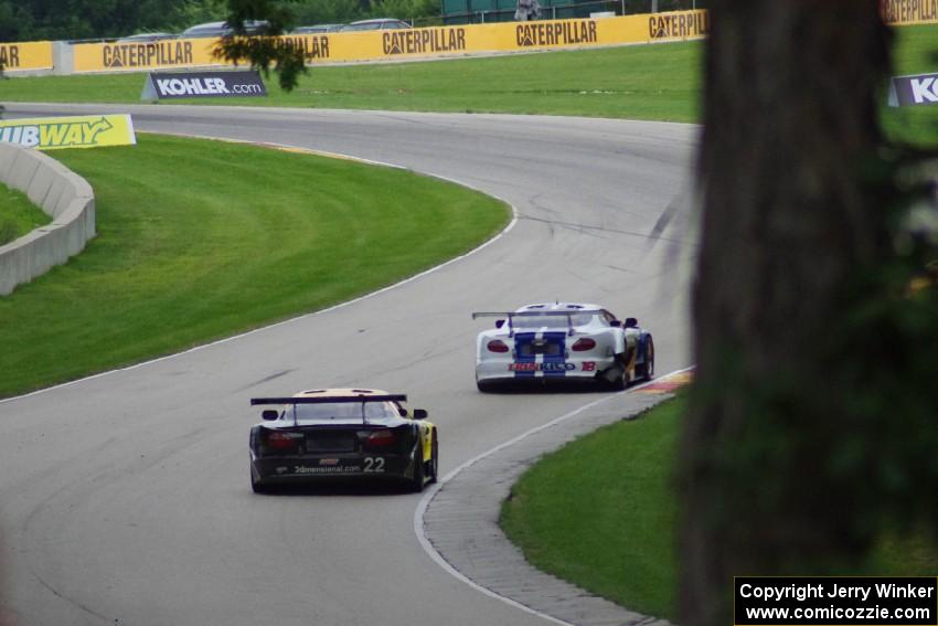 Daniel Ramoutarsingh's Jaguar XKR and Carlos de Quesada's Jaguar XKR head uphill into turn 13