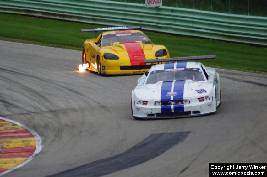 Cliff Ebben's Ford Mustang gets past Tony Ave's Chevy Corvette