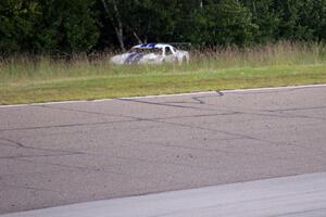 Cliff Ebben's Ford Mustang was on the outside of turn one after colliding with Amy Ruman's Chevy Corvette at the start