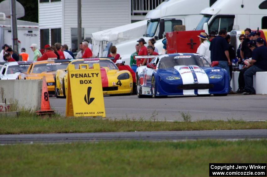 Daniel Ramoutarsingh's Jaguar XKR, Tony Ave's Chevy Corvette, David Jans' Ford Mustang and Cliff Ebben's Ford Mustang in the pit