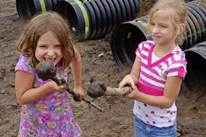 Taunting the photographer with mud balls on the end of sticks