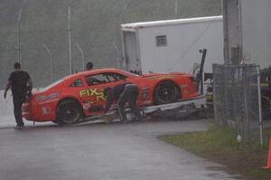 Tom Sheehan's Chevy Camaro is loaded onto the trailer during the rainy MX-5 Cup race and is a DNS