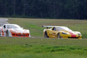 Tony Ave's Chevy Corvette passes Simon Gregg's Chevy Corvette as the rain starts to fall