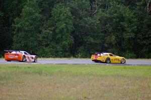 Tony Ave's Chevy Corvette passes Simon Gregg's Chevy Corvette as the rain starts to fall