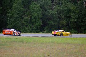 Tony Ave's Chevy Corvette passes Simon Gregg's Chevy Corvette as the rain starts to fall