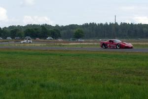 Amy Ruman's Chevy Corvette keeps ahead of Cliff Ebben's Ford Mustang in the rain