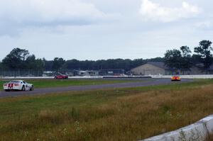 Amy Ruman's Chevy Corvette tries to hold off Tony Ave's Chevy Corvette and Cliff Ebben's Ford Mustang