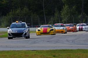 The field keeps behind the pace car after David Jans' wreck