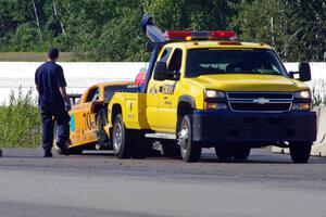 David Jans' Ford Mustang goes behind the wall after crashing at turn 13